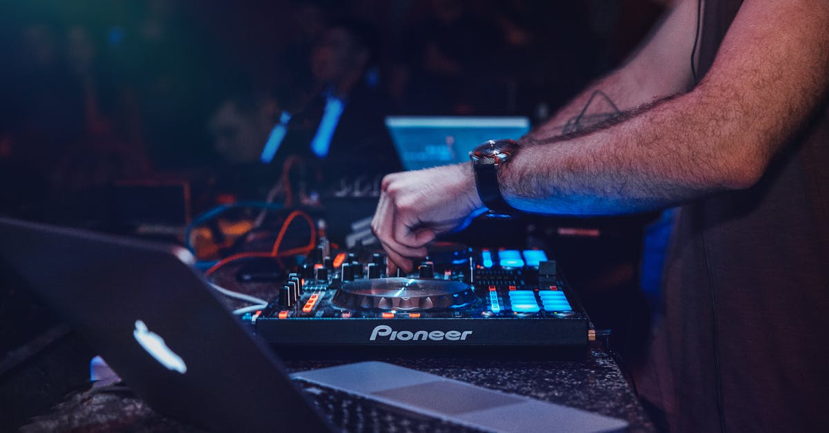 DJ performing with mixer in a vibrant nightclub setting. Perfect for entertainment and technology themes.